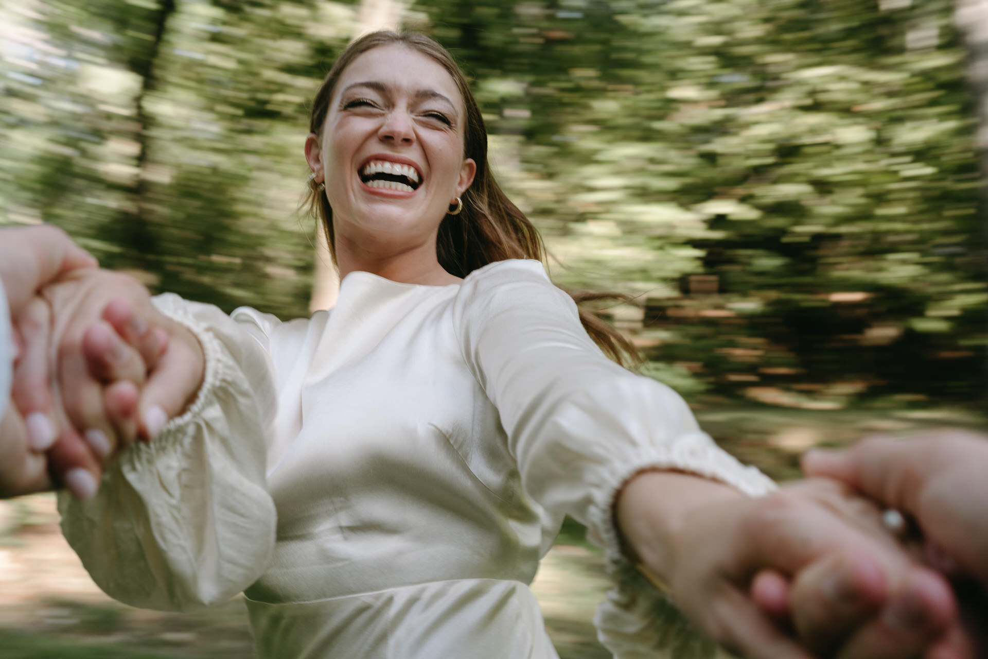 bride laughing and spinning with groom at rehearsal dinner